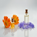 Essential oil bottles with flowers around them